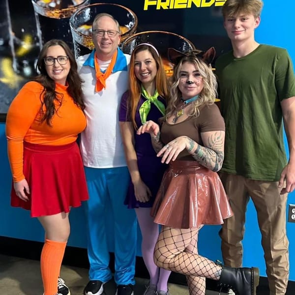 Five people dressed as Scooby-Doo characters pose together at One Eyed Jacks bar.