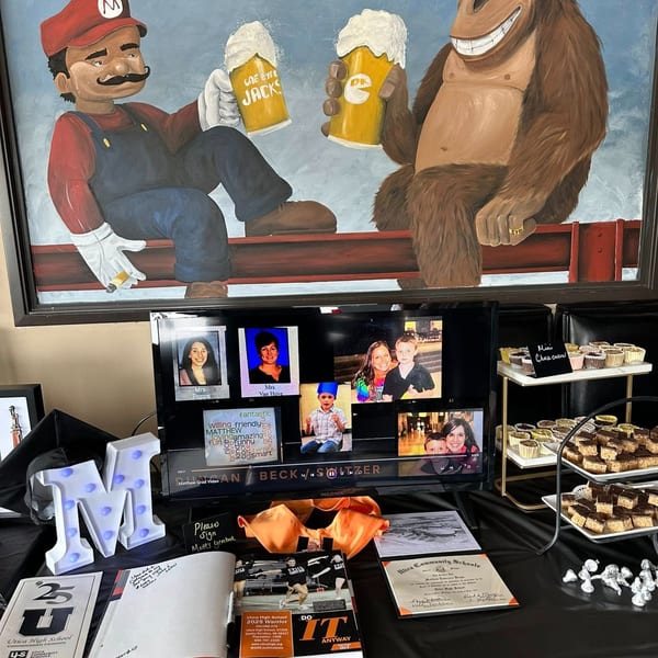 A One Eyed Jacks painting of Mario and Donkey Kong toasting beers above a dessert table.