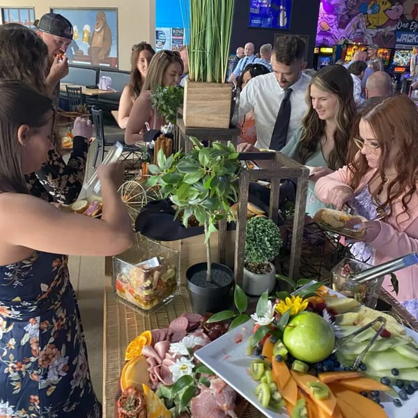 Guests at One Eyed Jacks bar-and-grill enjoy a buffet with charcuterie and fruit platters.